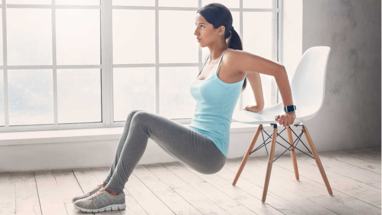 Woman doing tricep dips on chair