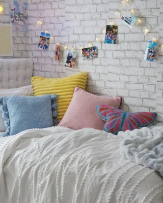 A cozy, colorful dorm room with pictures on the wall