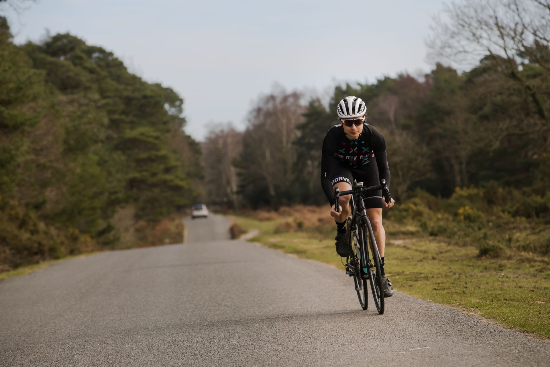 Image shows a rider cycling outside.