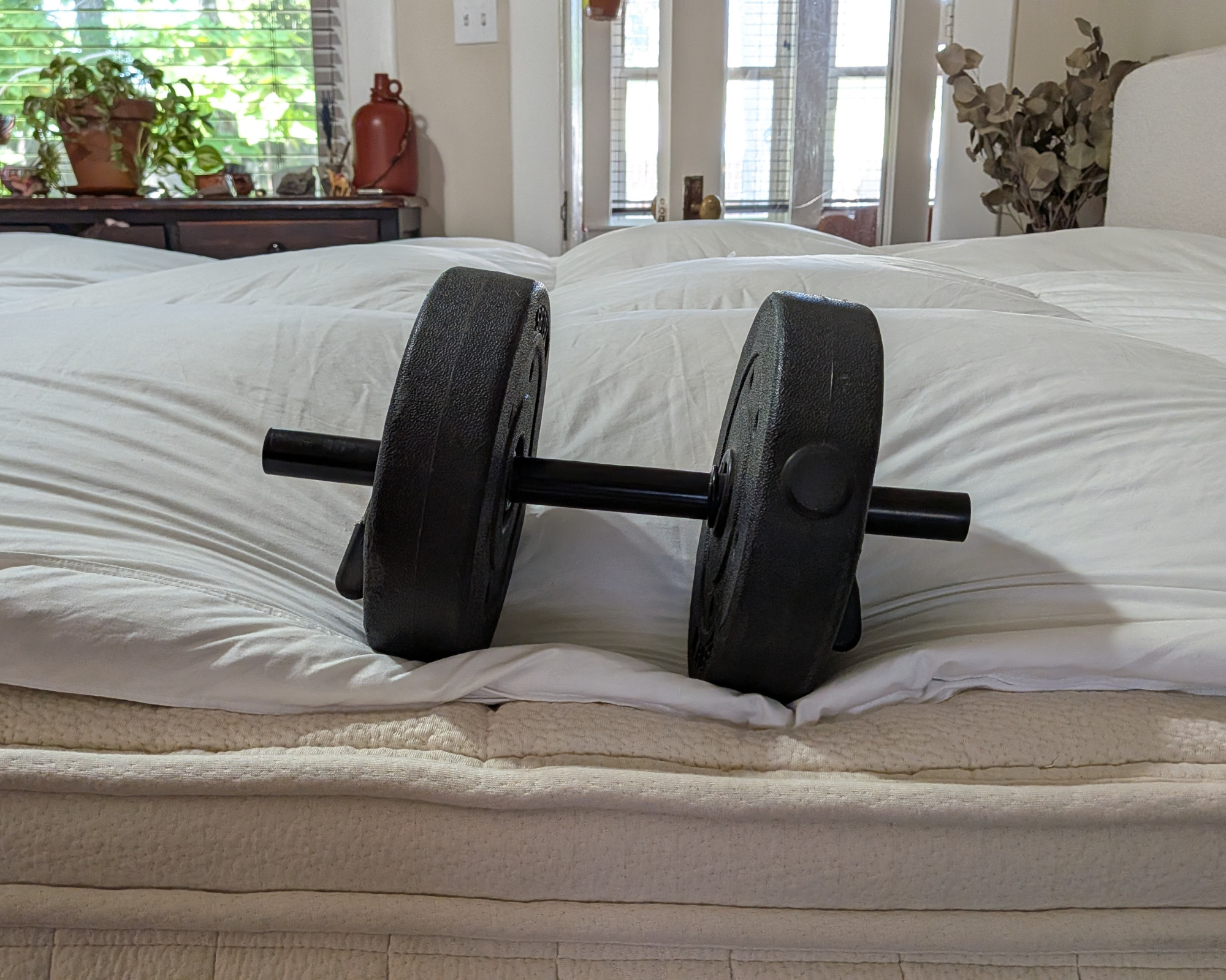 A weight placed on the edge of the Avocado Down Mattress Topper.