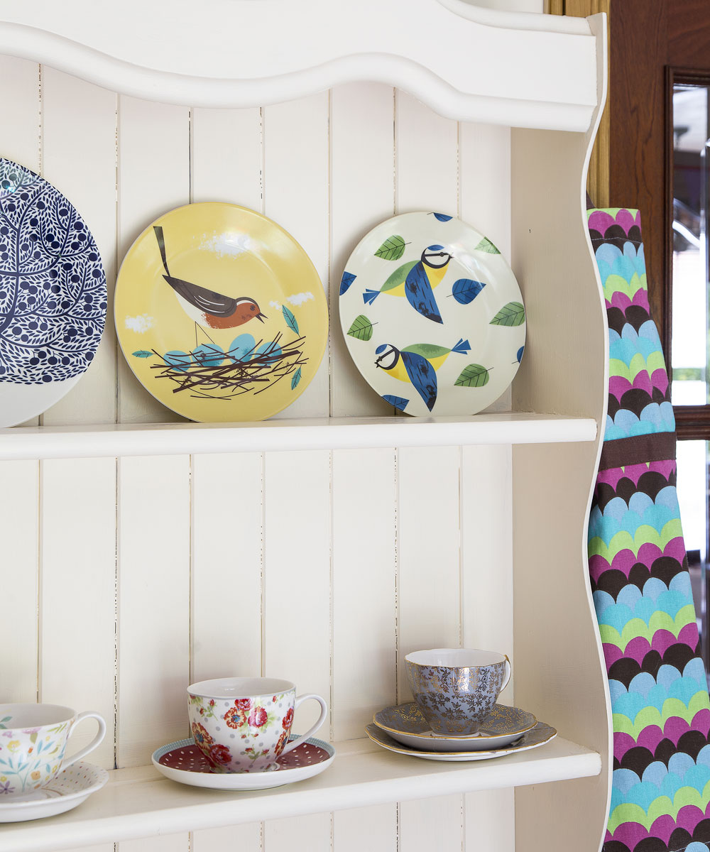 white shelves with dishes and cups