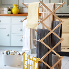 wood airer with towels hanging on it