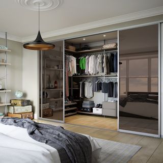 Bedroom with sliding glass doors onto a walk-in wardrobe