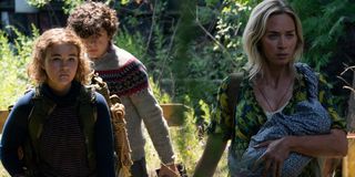 A Quiet Place Part II Millicent Simmonds, Noah Jupe, and Emily Blunt walking through the woods
