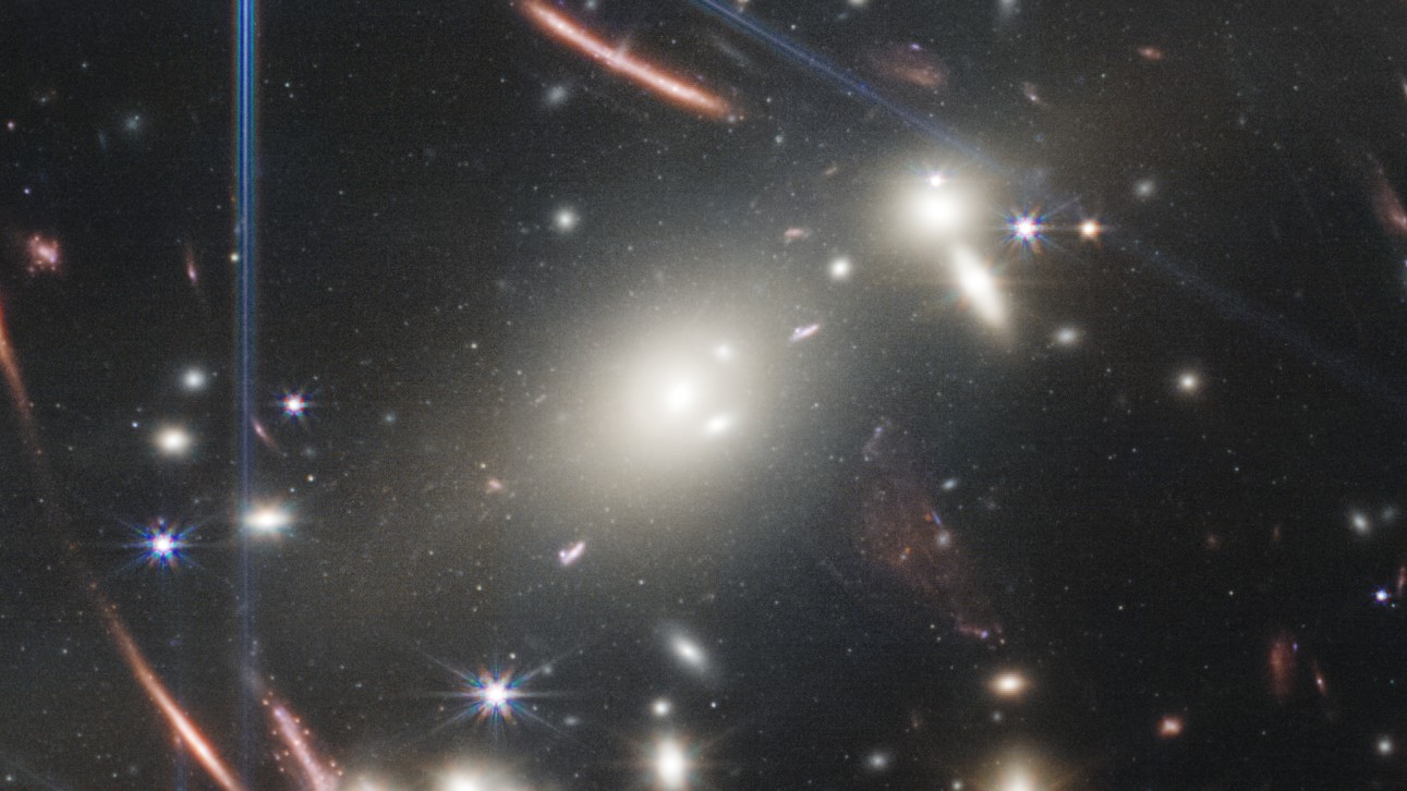 In the center of JWST's deep field image, bright white galaxies crash into each other.