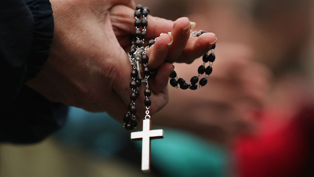 A priest holding a crucifix 