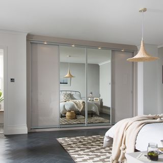 Neutral grey bedroom with sliding door wardrobes with mirror panels
