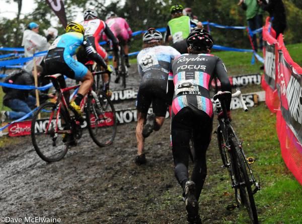 Chris Jones (Rapha Focus) and a large group at the barriers on lap one