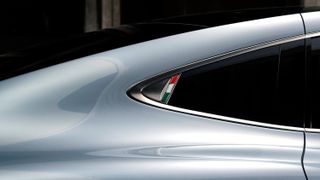 Detail of Aehra electric SUV with Italian flag
