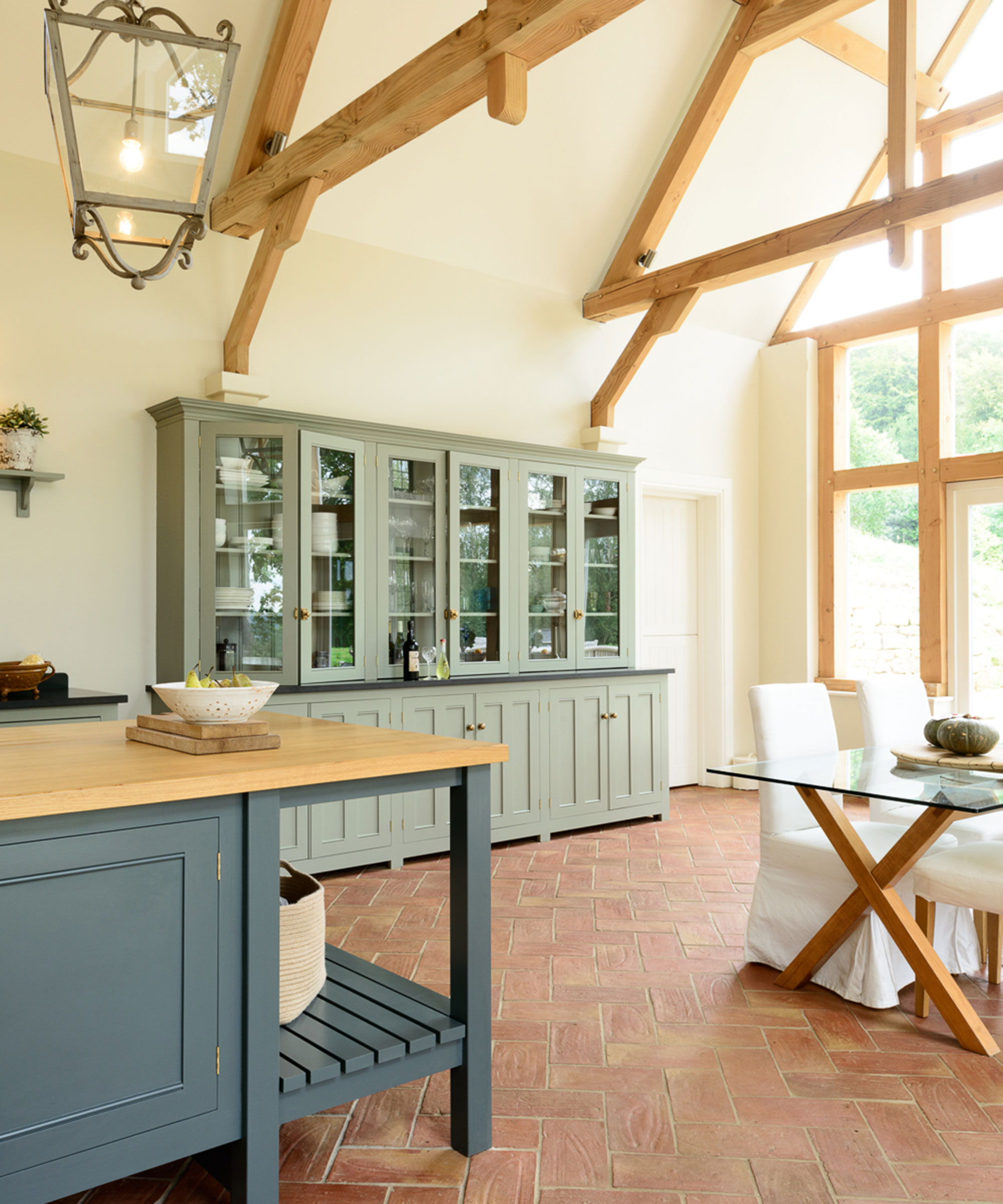 Shaker style freestanding blue and green kitchen in barn conversion