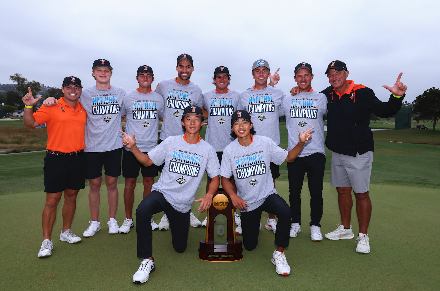 Oklahoma State University hold the NCAA Division 1 trophy