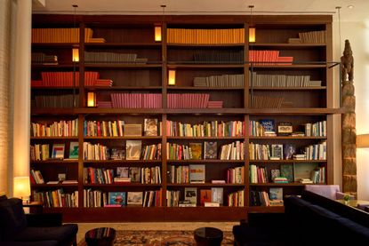 Shelves filled with books at The Mercer hotel library, New York