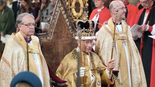 Britain's King Charles III sits on the throne wearing St Edward's Crown during the Coronation Ceremony inside Westminster Abbey in central London on May 6, 2023. The set-piece coronation is the first in Britain in 70 years, and only the second in history to be televised. Charles will be the 40th reigning monarch to be crowned at the central London church since King William I in 1066. Outside the UK, he is also king of 14 other Commonwealth countries, including Australia, Canada and New Zealand. Camilla, his second wife, will be crowned queen alongside him and be known as Queen Camilla after the ceremony. (Photo by Jonathan Brady / POOL / AFP)