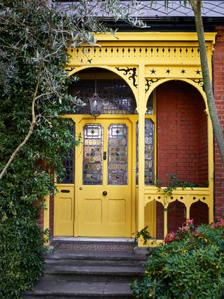 yellow front door and porch