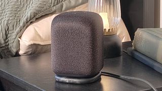 The Sony LinkBuds Speaker on a shelf beside a bed.