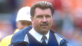 Mike Ditka preparing for a football game while on the field as the coach of The Chicago Bears.