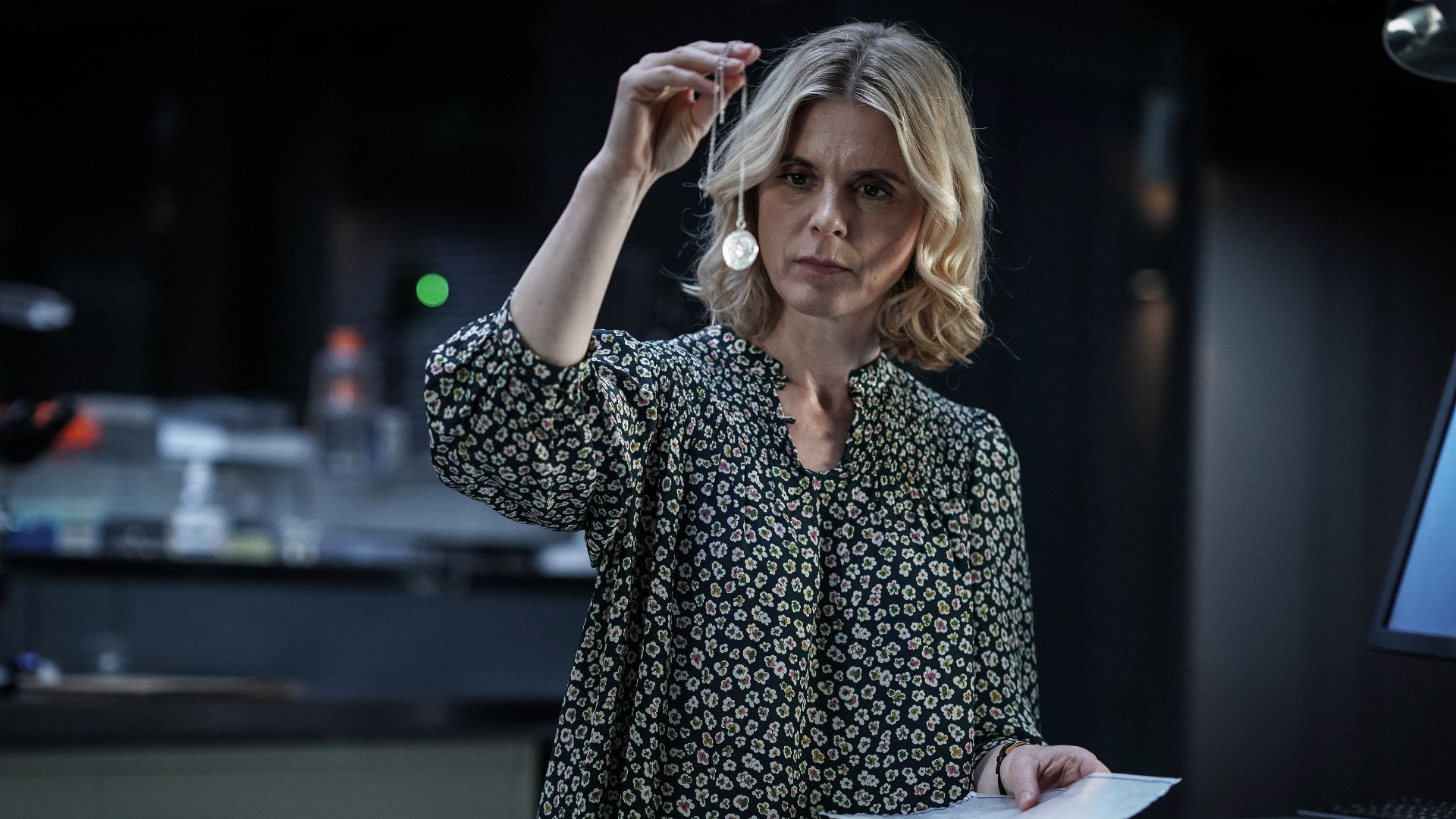 Nikki Alexander (Emilia Fox) examines a necklace in Silent Witness season 26