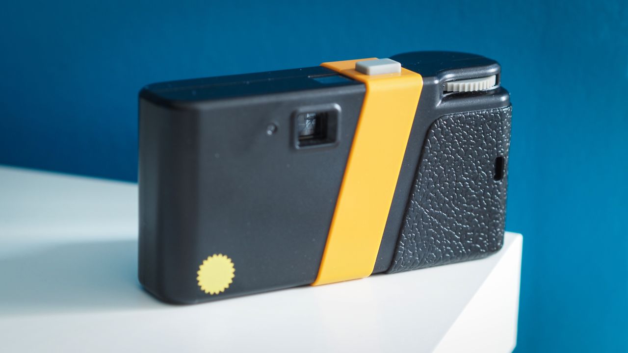 Lifestyle photo of the Flashback camera against a light blue background