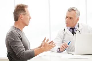 A man talks with his doctor.