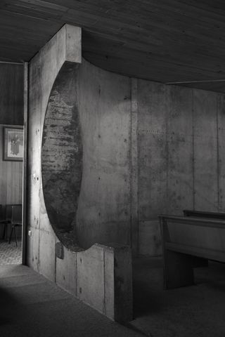 St Anthony’s Church in Sydney was designed in 1968. A black and white photo of back of the chapel which has curved concrete walls and sittings benches.
