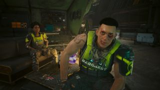 Two individuals in bright green painted flak jackets facing camera