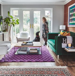 Colourful living room with green sofa and purple carpet