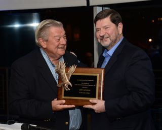 Les H. Read (l.), a longtime former HBO executive and the first-ever honorary member of the SCTE’s Circle of Eagles, presents the honor to the circle’s second-ever honorary member, Cable Center CEO Larry Satkowiak, at the group’s dinner during Cable-Tec Expo in Denver.