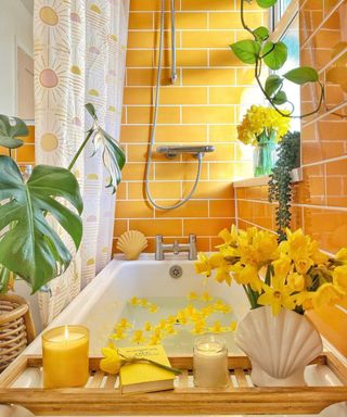 Yellow bathroom with white bathtub and yellow flowers