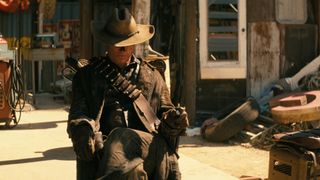 "The Ghoul" (Walton Goggins) sitting in a chair in bounty hunter garb in the Fallout TV show