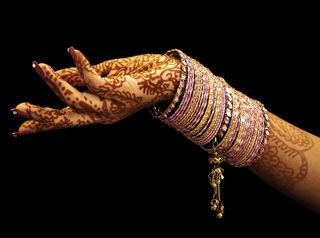 Indian brides decorate their hands and feet with henna.