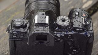 Water droplets on the dials of the OM System OM-1 camera