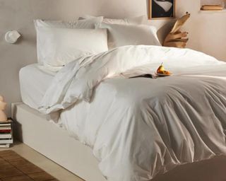 Brooklinen organic bed sheets on bed white with fruit and styled accessories