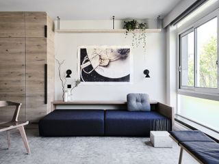 grey apartment living room with dark blue sofa