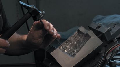 Worker perfecting a Lalique vase