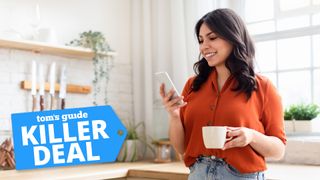 Stock image of woman standing in a kitchen and looking at her phone with 'Killer Deal' badge overlaid