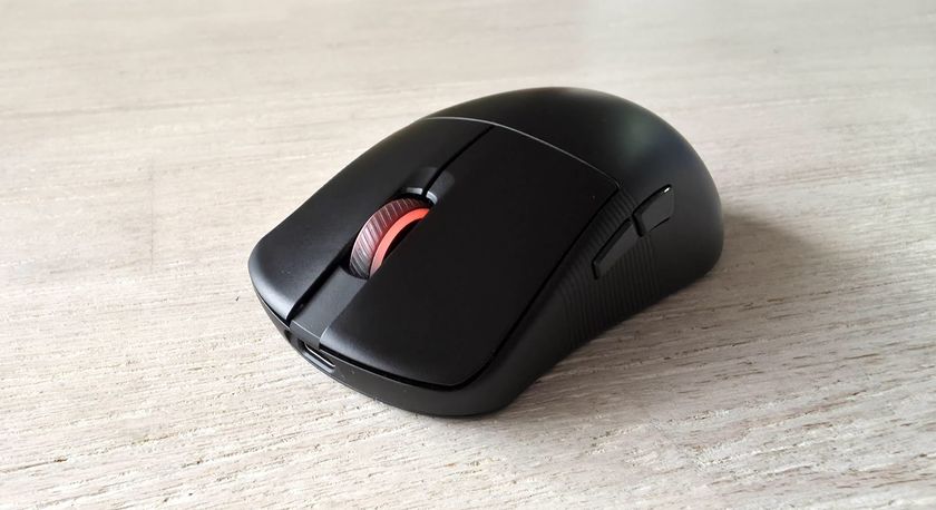 The Asus ROG Harpe Ace Mini gaming mouse on a table