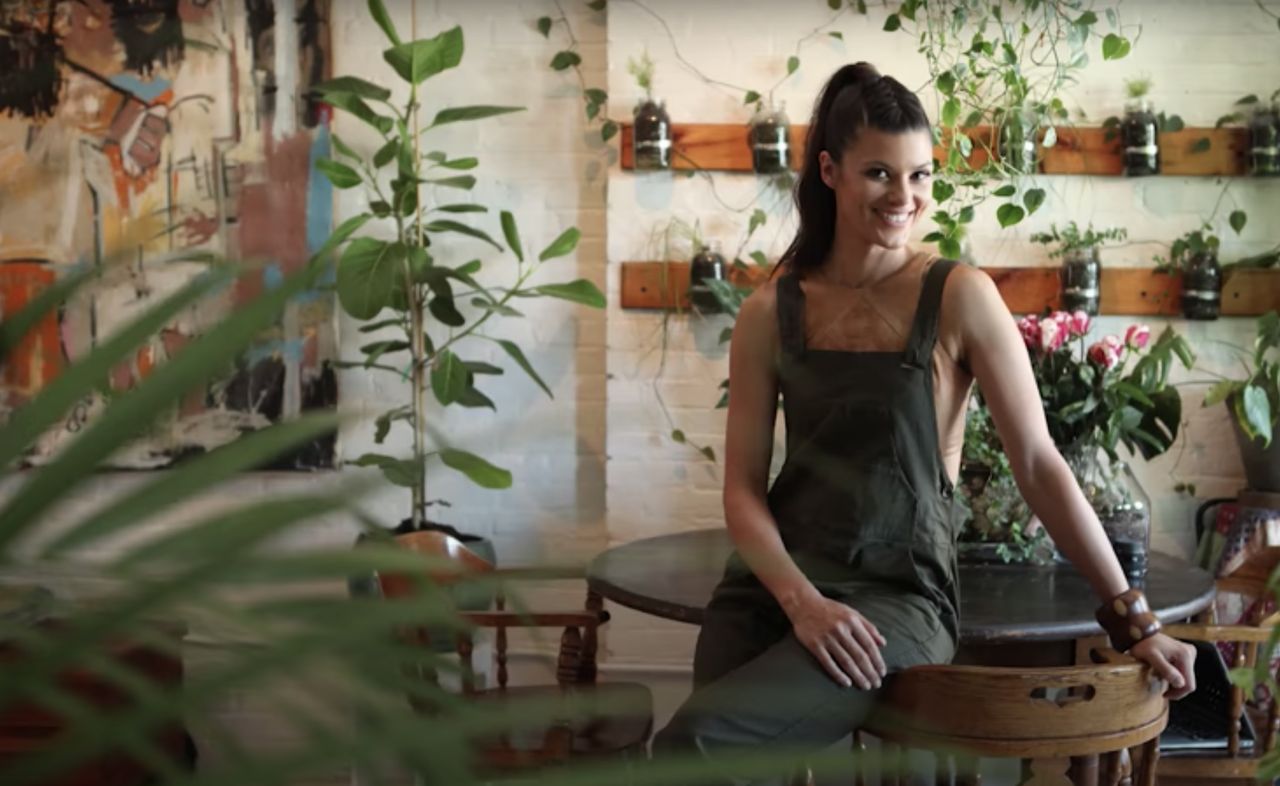 Summer Rayne Oakes in Brooklyn apartment filled with house plants