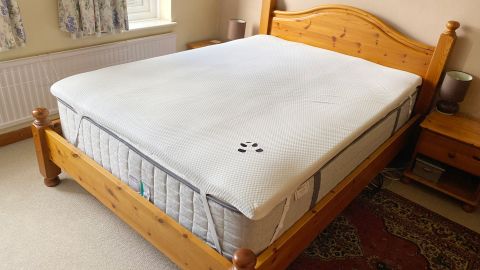 The Panda Bamboo Mattress Topper on a bed in a bedroom