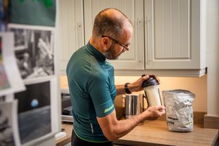 Male cyclist making a recovery drink
