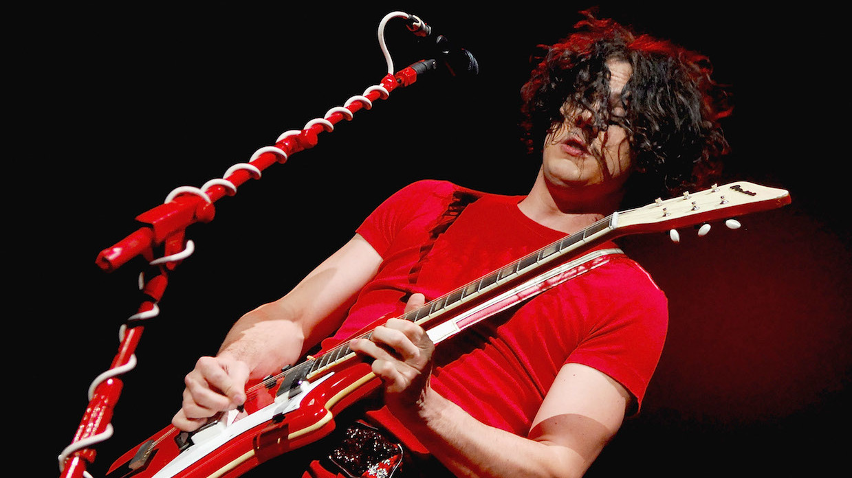 Jack White playing guitar onstage