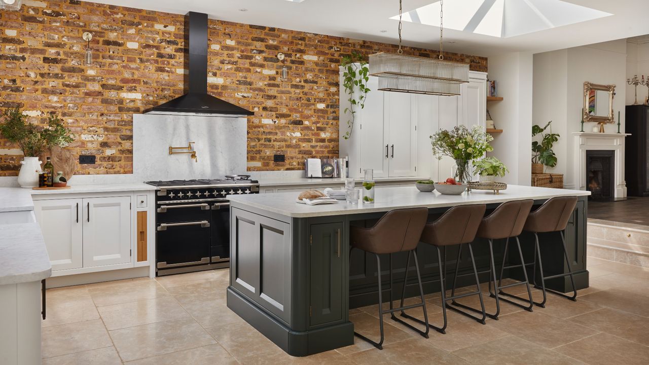 Kitchen with brick walls, dark cabinetry, white countertops