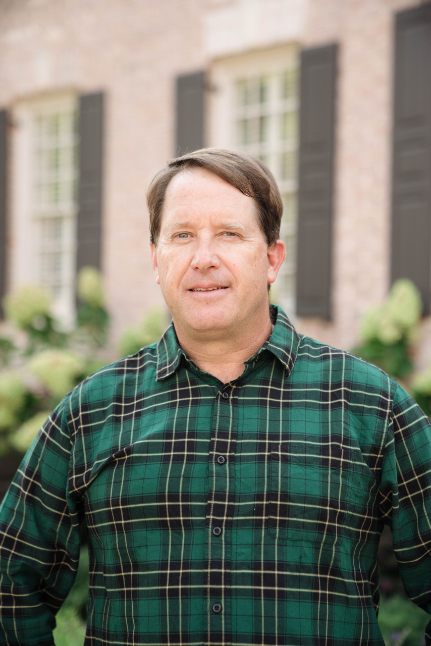 Headshot of man in a green shirt