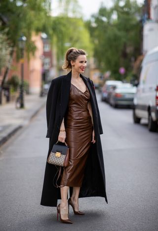 Alexandra Lapp is seen wearing MEDEEA double breasted Long Coat in black, MANOKHI dress Jona in brown, GUCCI Padlock GG Supreme in brown and black, CHRISTIAN LOUBOUTIN So Kate pumps in brown on May 22, 2021 in Dusseldorf, Germany.