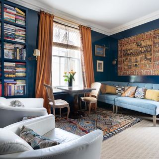 Living room with blue walls and large bookshelves