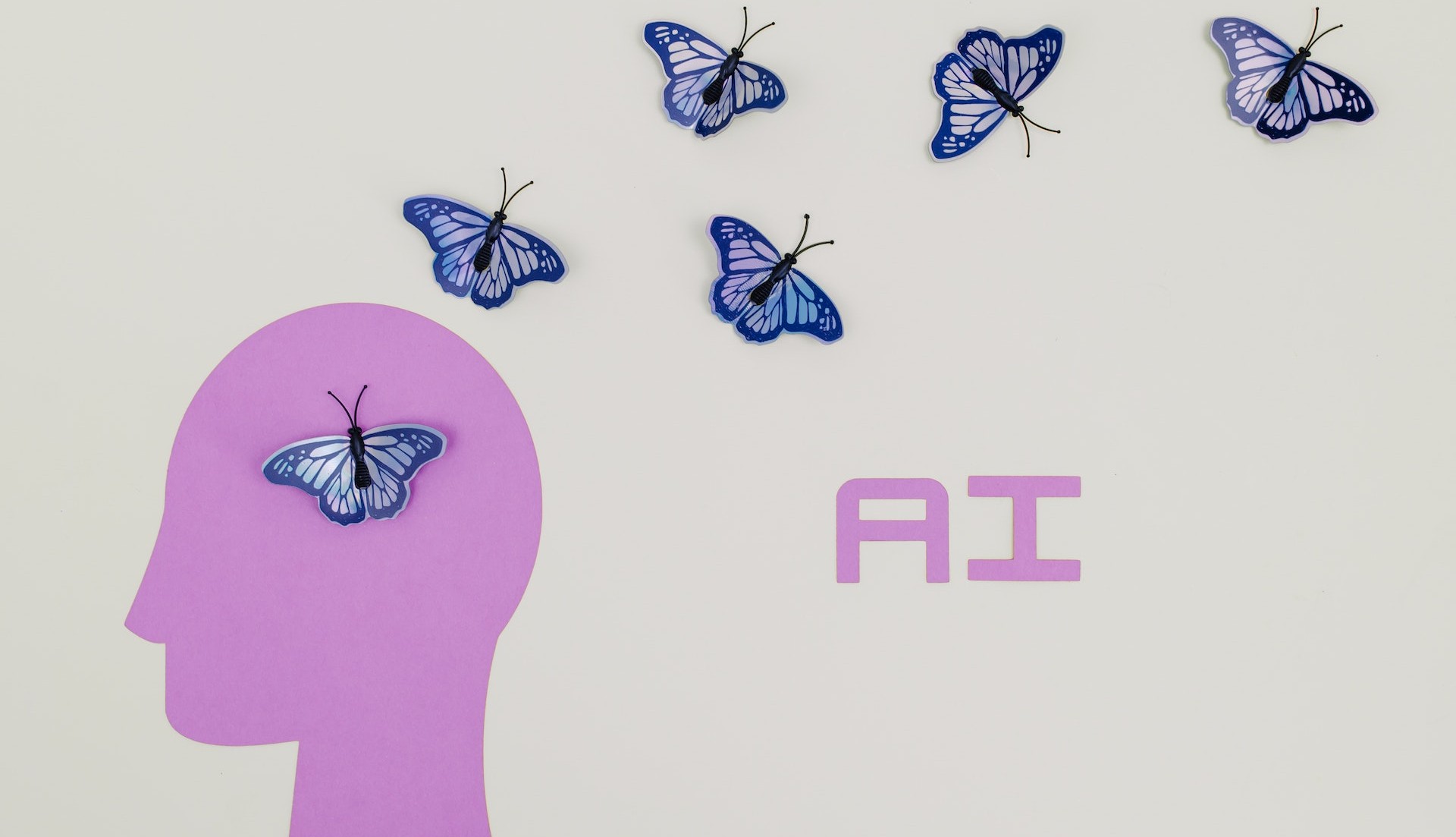 Image of butterflies around person's head and the words 'AI'