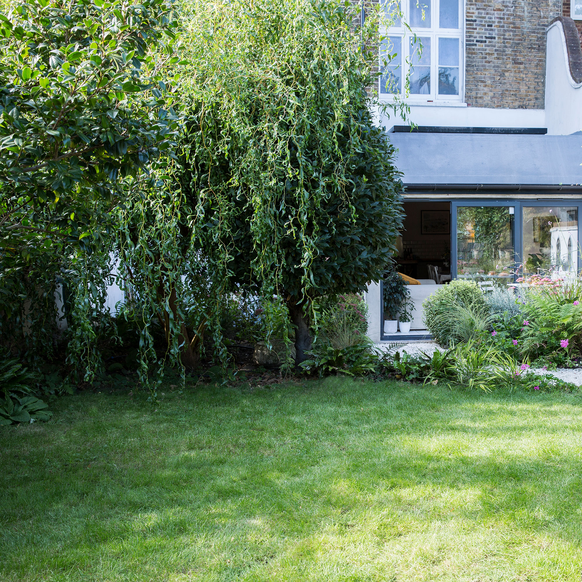 exterior of house with green land and green foliage