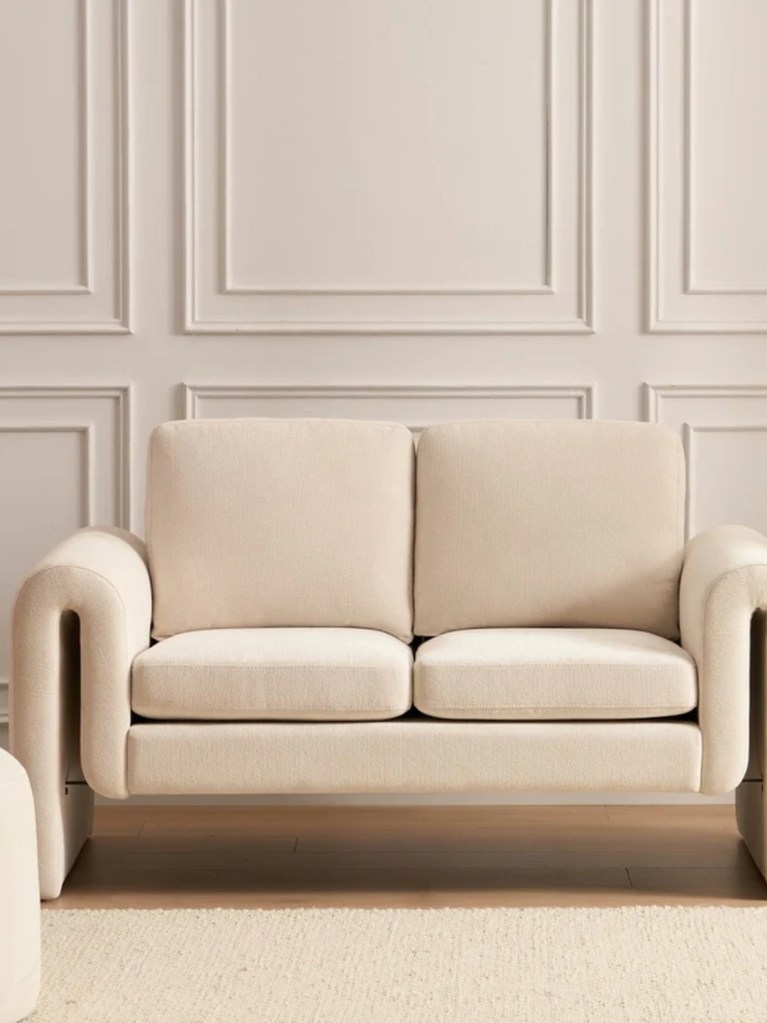 A compact two-seater cream sofa from DUSK