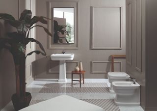 A large bathroom with panelled walls, a sink, toilet and bidet