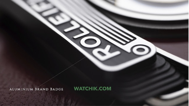 A macro shot focusing on the textured aluminium brand badge that reads "Rollei" on the side of the watch.