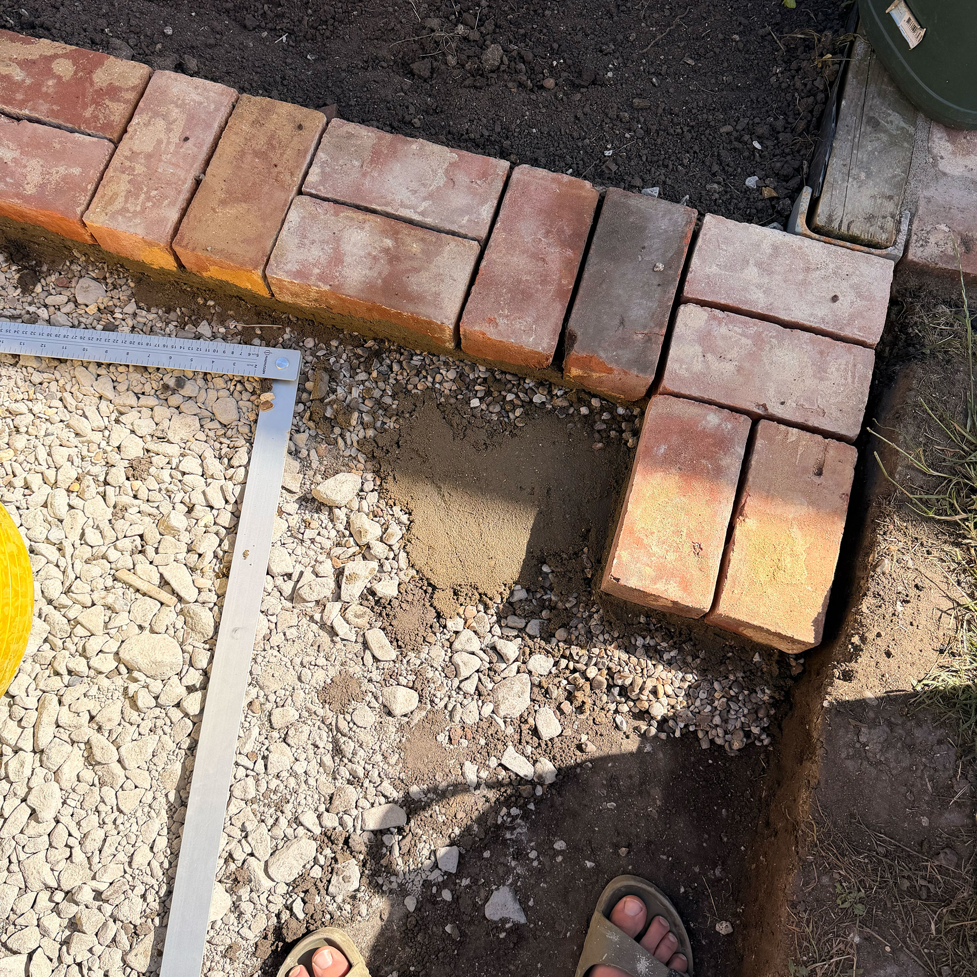 Bricks being laid in ground in garden